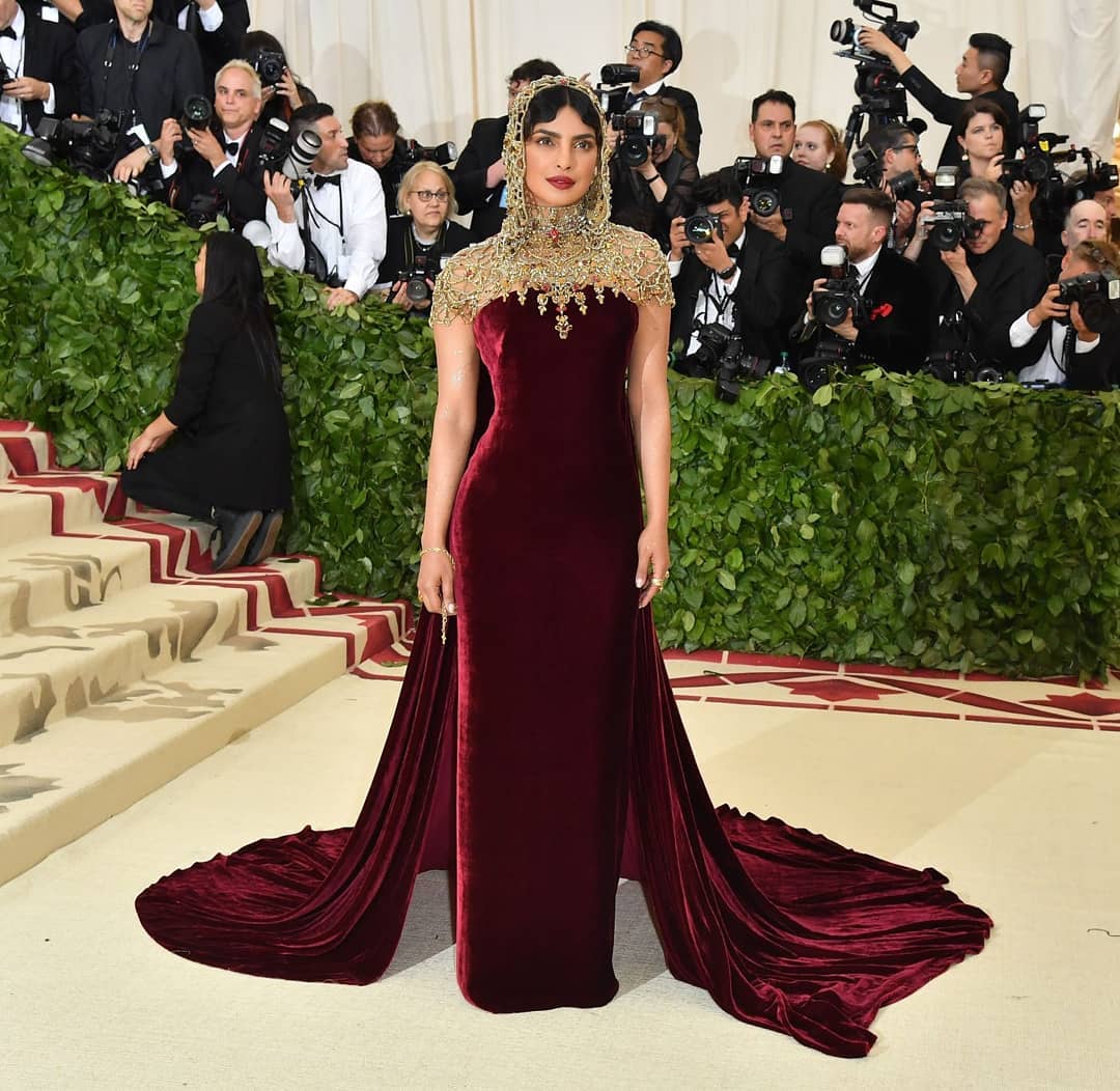 In 2018, Priyanka Chopra Jonas, in her second appearance at the Met, again chose Ralph Lauren for the theme Heavenly Bodies: Fashion and the Catholic Imagination. She wore an ethereal Madonna-inspired velvet maroon gown with detailed lacework and a lacework headpiece that brought so much drama. Priyanka was yet again a part of many best-dressed lists